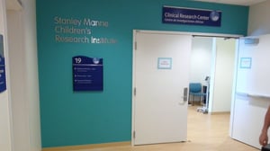 INTERIOR DIRECTIONAL SIGNAGE IN HOSPITAL HALLWAY