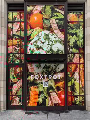 Large, two level window cling of fresh food at the window entrance of Fox Trot