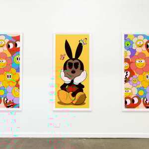 Art displayed at Cherry Mountain Arts shows a vibrant cartoon character on a Giclee print.