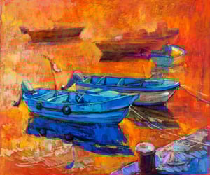 Giclee print sample showing two blue boats on sunset orange water.