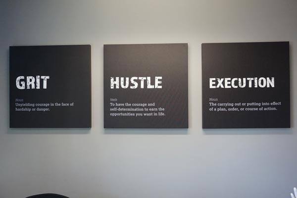 Motivational messages are posted on individual office walls.